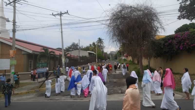 The procession starts outside of COAR, carrying the cross