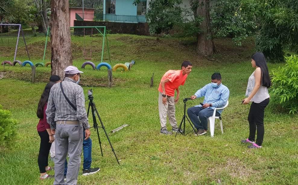 Raúl learns about positioning subjects for a shot during community film school - 2021