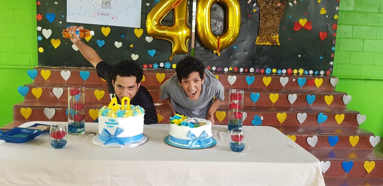 Raúl (left) and housemate Ricardo (left) look forward to a slice of cake at COAR's 40th anniversary celebration - 2020