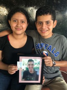 The residents hold Raul's photo as a gentle remembrance